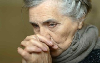 Seniorin beim Gebet